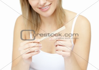 Portrait of a smiling woman filing her nails