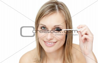 Radiant woman putting mascara