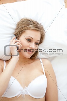 Radiant woman in underwear talking on phone
