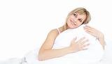 Cheerful woman hugging her pillow