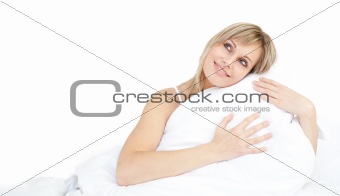 Cheerful woman hugging her pillow