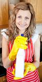 Beautiful blond woman holding a detergent spray