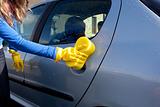 Close-up of a woman cleaning her car