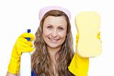 Cheerful woman holding a sponge and a detergent spray