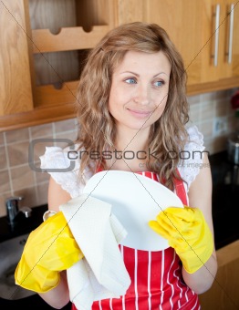 Smiling caucasian woman drying dishes 