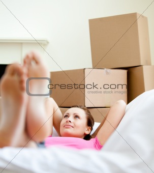 Cute woman having a break between boxes