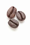 Three Roasted Coffee Beans Isolated on White with Narrow Depth of Field.