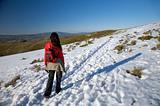 woman with rucksack on snow path