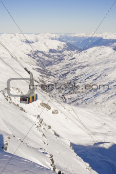 Large cable car up a mountain valley