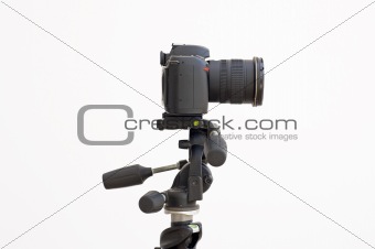 Digital SLR camera on a tripod isolated on white