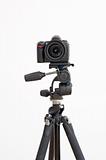 Digital SLR camera on a tripod isolated on white