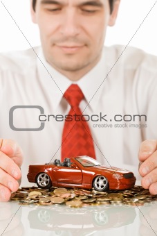 Businessman with red toy car