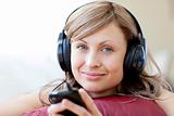 Relaxed woman is listening the music in the living-room 