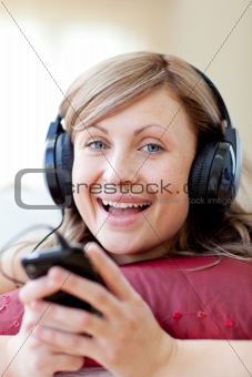 Happy woman is listening the music in the living-room 