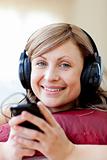 Delighted woman is listening the music in the living-room 