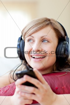 Caucasian woman is listening the music in the living-room 