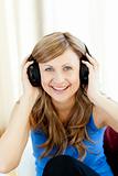 Smiling woman is listening the music in the living-room 