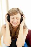 Cute woman is listening the music in the living-room 