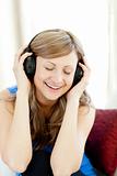 Beautiful woman is listening the music in the living-room 