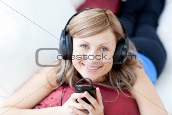 Teen woman is listening the music in the living-room 