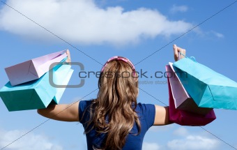 Happy woman holding shopping bags outdoor 