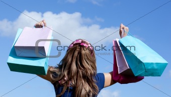 Cute woman holding shopping bags outdoor 