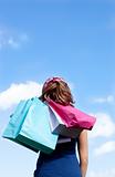 Smiling woman holding shopping bags outdoor 