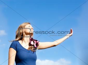 Attractive  blond woman against blue sky