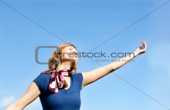 Smiling  blond woman against blue sky