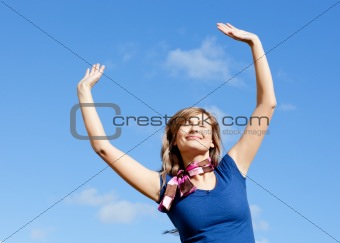 Bright blond woman punching tha air against blue sky