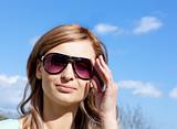 Portrait of a relaxed blond woman with sunglasses outdoors