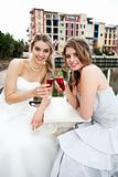 Young Women in Gowns Sharing a Drink