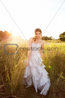 Attractive Young Woman Standing in the Grass