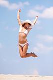 Young woman jumping on a beach