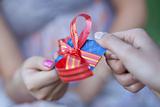 Credit card with a bow in a gift to the young woman. Small depth