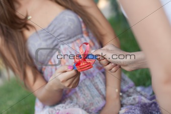 Credit card with a bow in a gift to the young woman. Low depth o