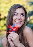 young woman holds a credit card in hands and smiles