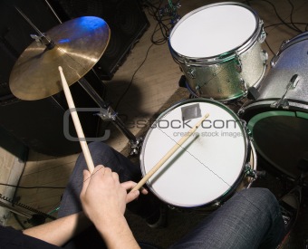 Drummer playing drumset.
