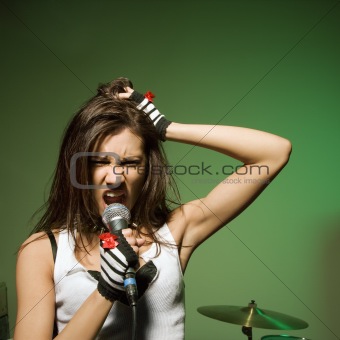 Female singing into mic.