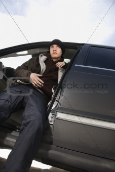 Teenager sitting in SUV.