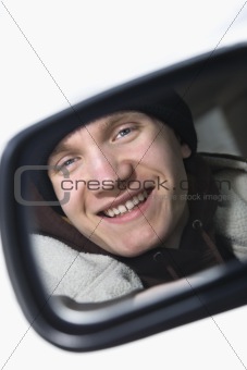 Teen in side view mirror.