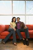 Couple sitting on couch.