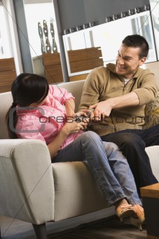 Couple fighting over remote.