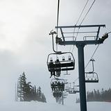 Skiers on chairlift.
