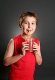 Child drinking fresh berry juice