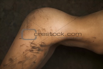 Muddy woman's torso.