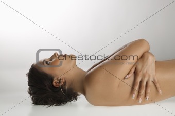 Nude woman lying down.