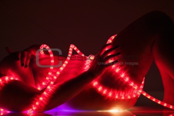 Nude woman with rope lights.