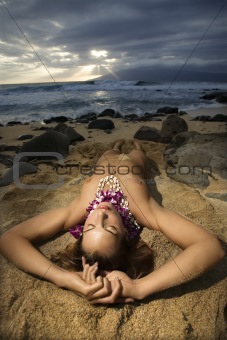 Nude woman lying on beach.