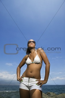 Woman on beach in bikini.